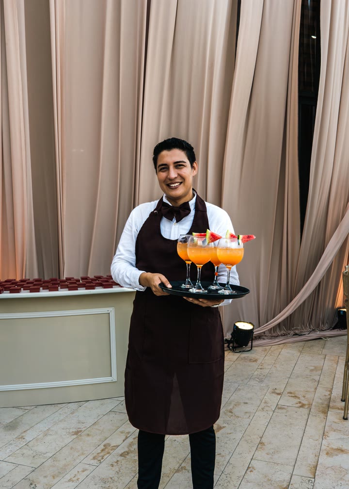 A server carrying a tray of drinks at an event