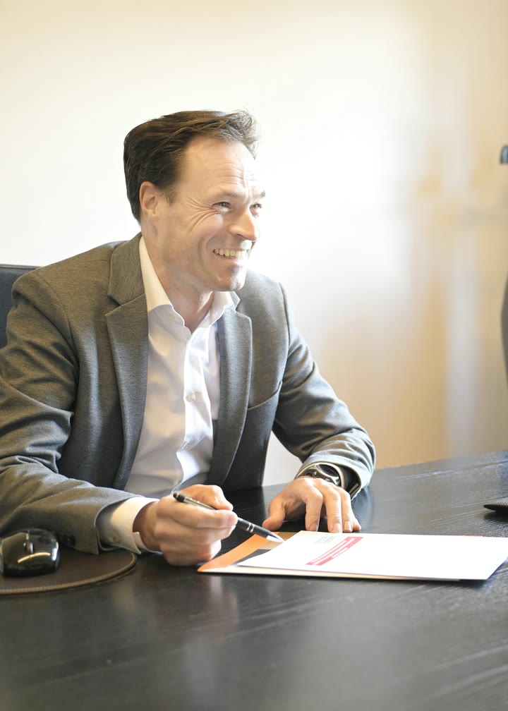 An attorney smiling across the desk at a client