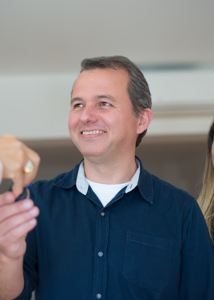 A happy buyer being handed the keys to a home